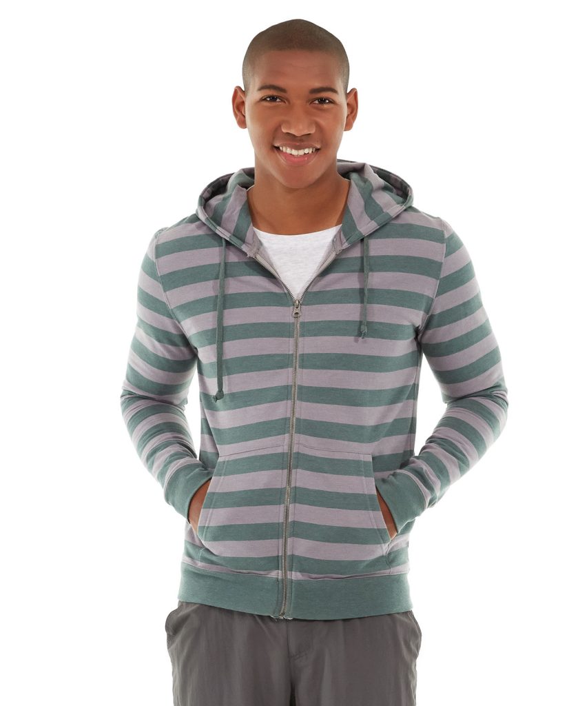 Male athlete wearing blue Ajax Full-Zip Sweatshirt while hiking on mountain trail