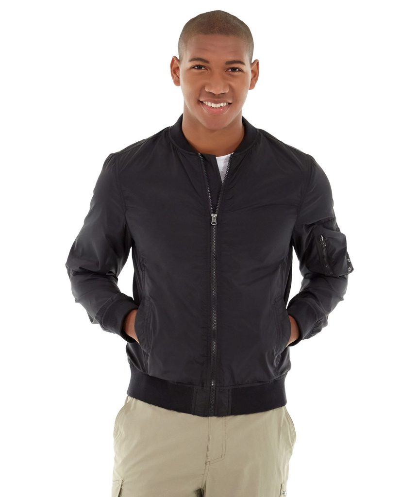 Athletic man wearing a navy blue fleece-lined jacket outdoors in mountain terrain
