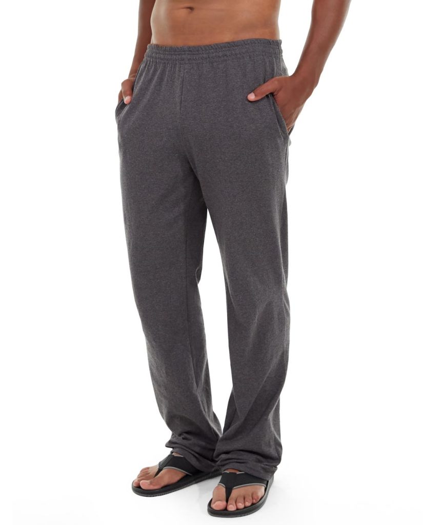 Male runner wearing black athletic pants mid-stride on urban street