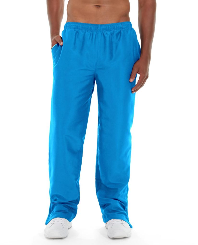 Male athlete wearing navy blue track pants, standing confidently on running track