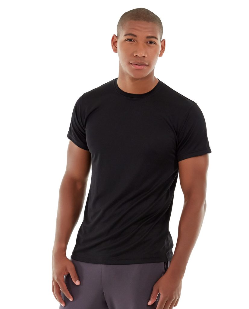 Male runner wearing gray performance t-shirt, determined expression, running on city street