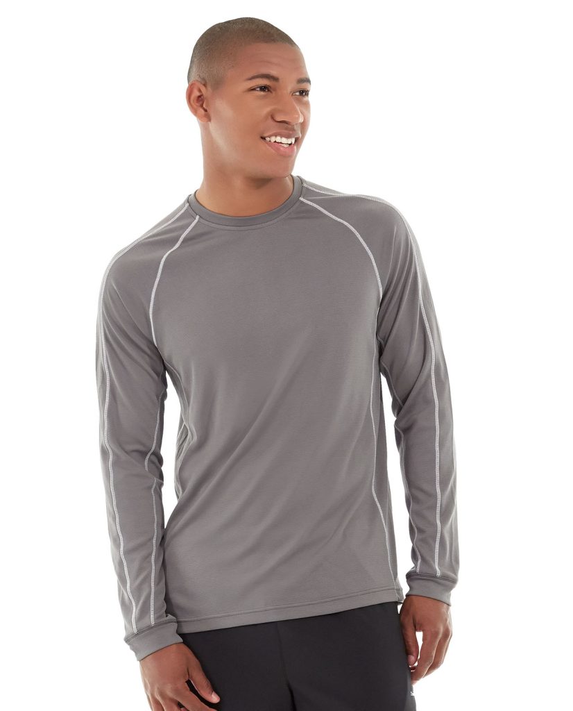 Athletic model wearing a light blue long-sleeve performance shirt in dynamic training pose