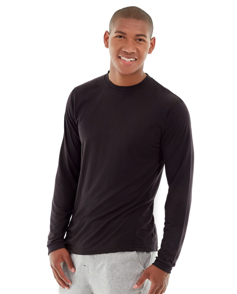 Male athlete in moisture-wicking long-sleeve shirt running on trail at sunrise