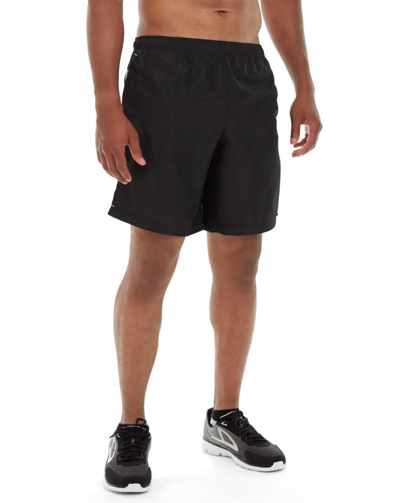 Male runner wearing blue Apollo running shorts, mid-stride on a trail