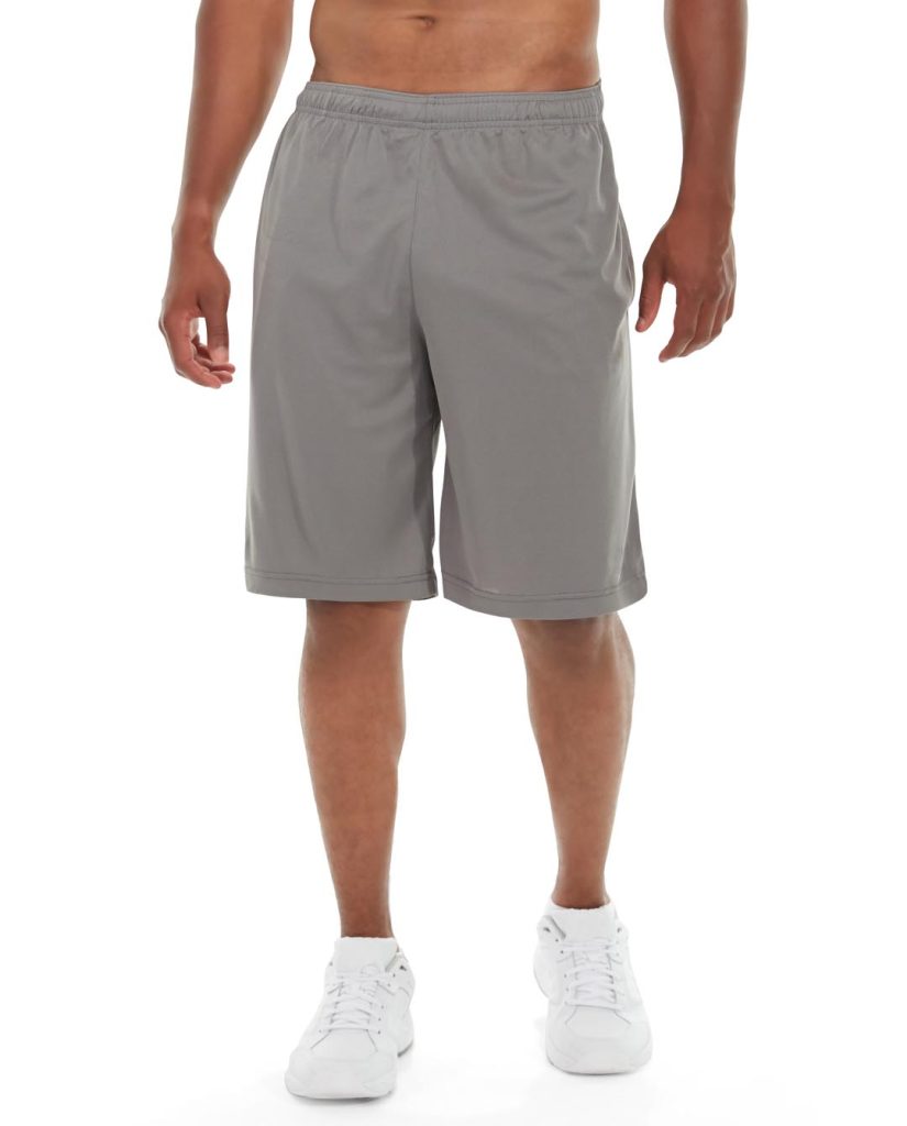 Male runner wearing light gray athletic shorts, mid-stride on a sunny trail