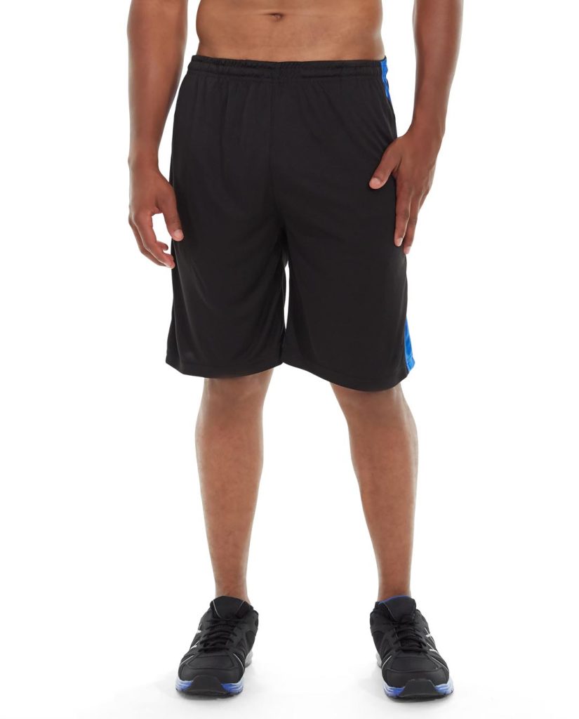 Male athlete wearing black performance shorts, mid-stride on running track