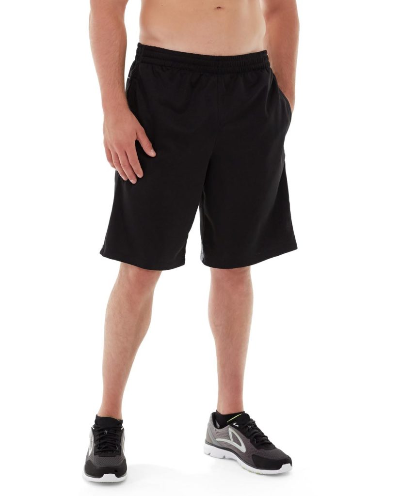 Athletic model wearing black Orestes fitness shorts mid-squat in a gym setting