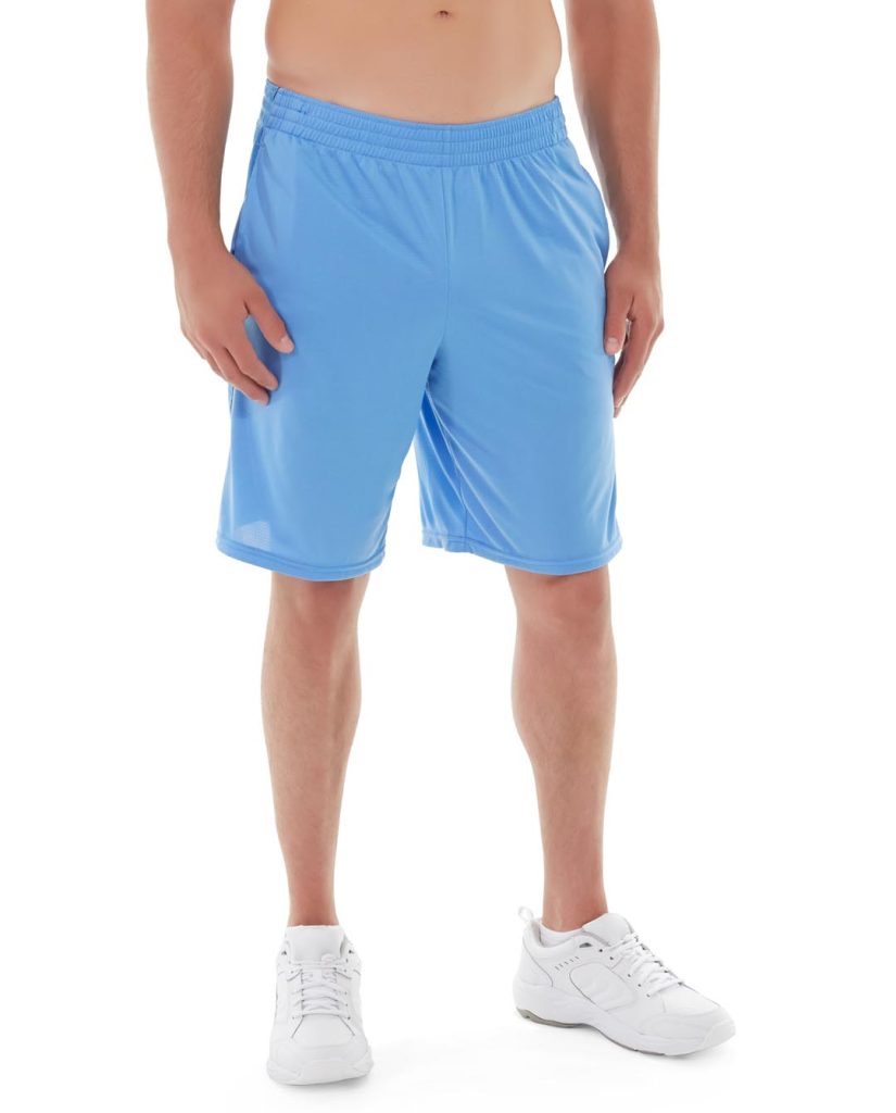 Person folding athletic shorts neatly on clean, organized workspace
